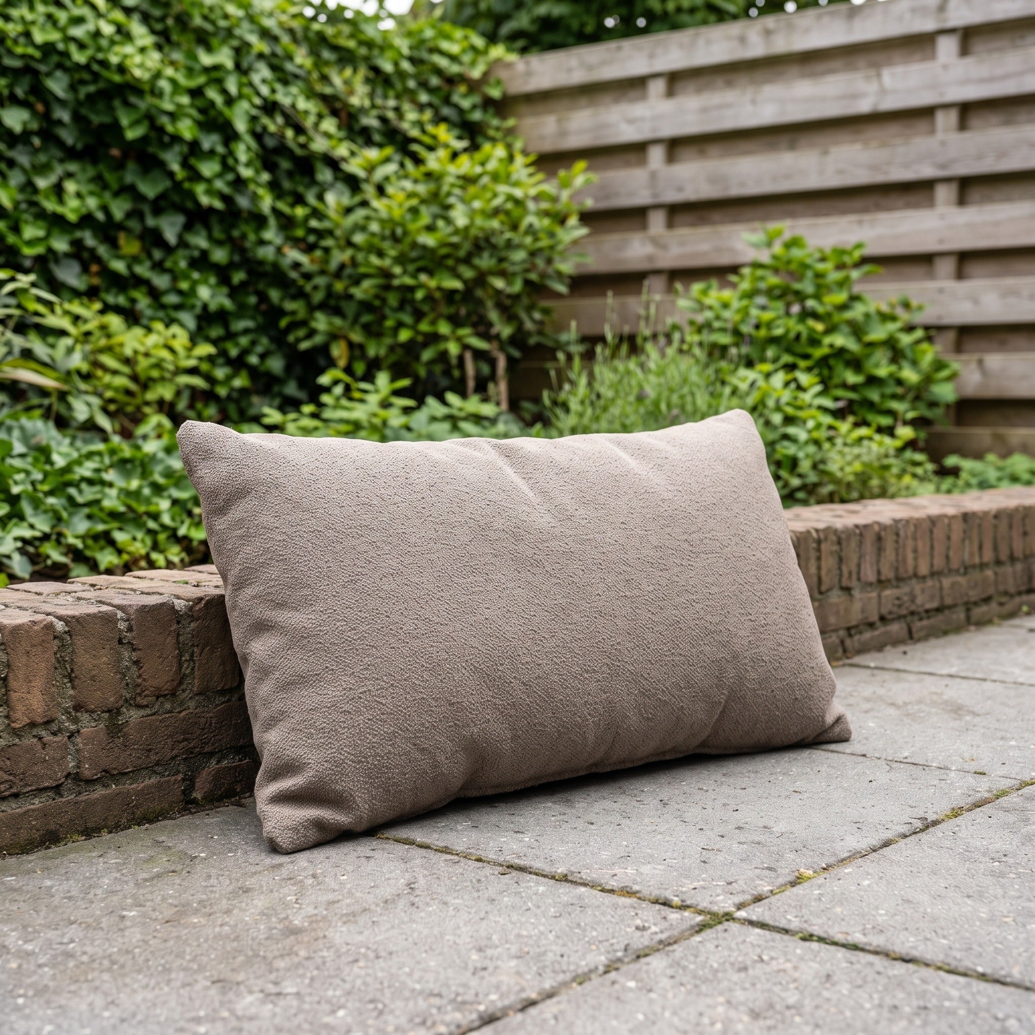 4 Seasons Outdoor sierkussen 30 x 60 cm Bouclé Clay in een Nederlandse tuinomgeving