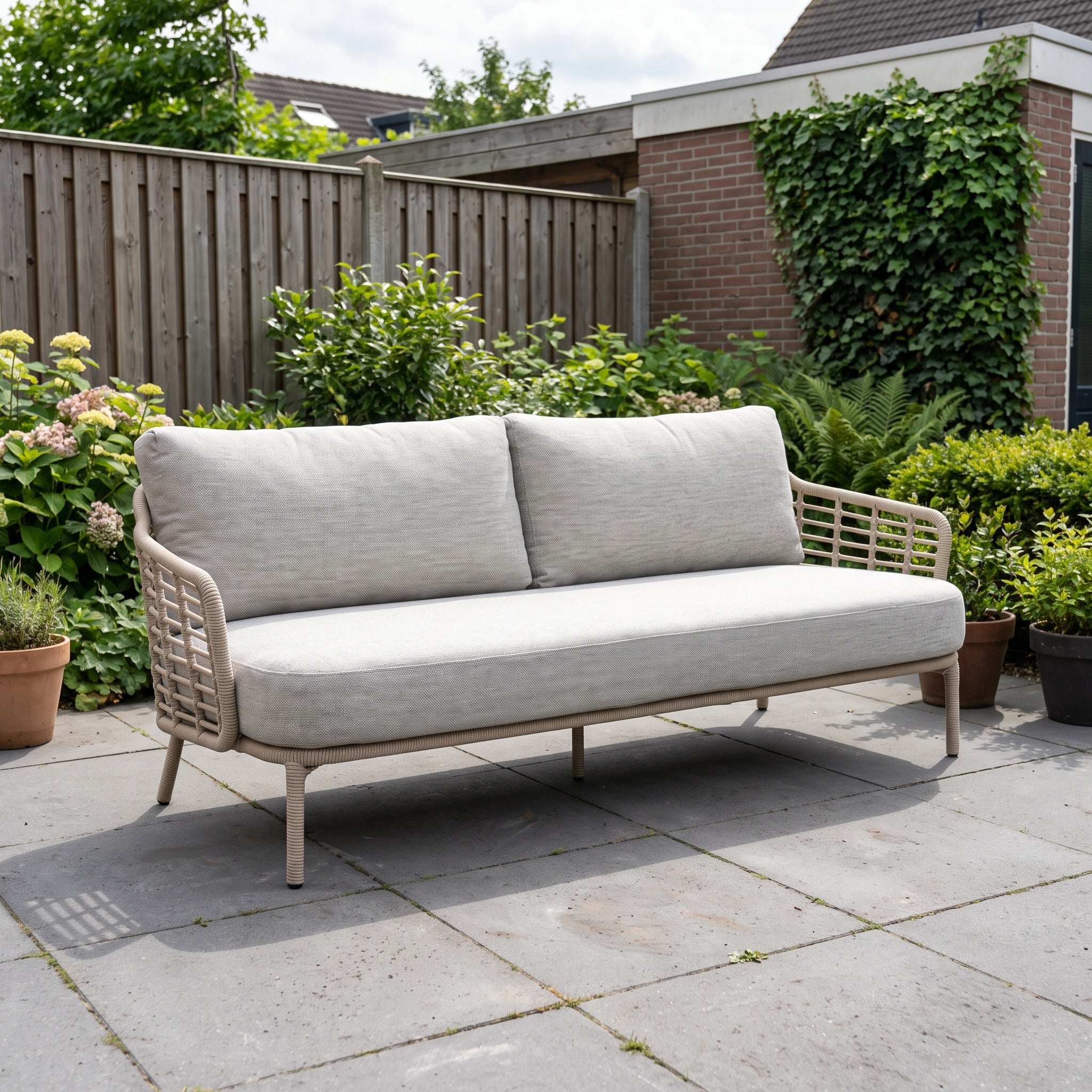 4 Seasons Outdoor Como 3-zits Loungebank in een Nederlandse tuinomgeving